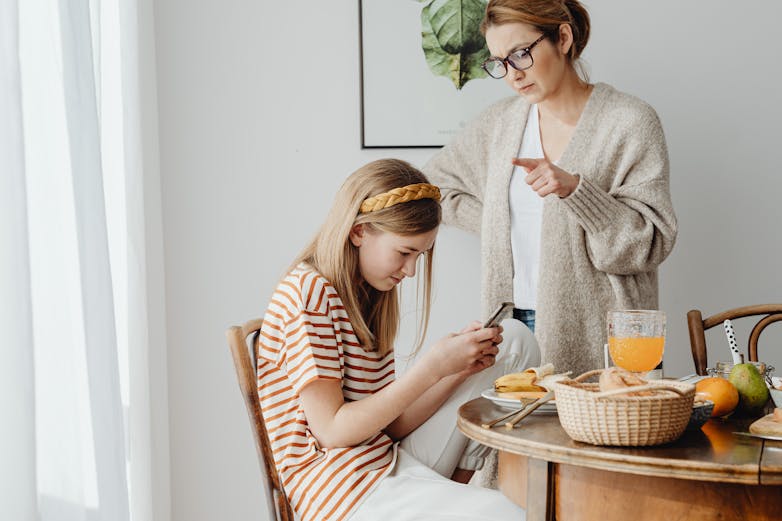 kid-busy-in-phone-while-mom-talking