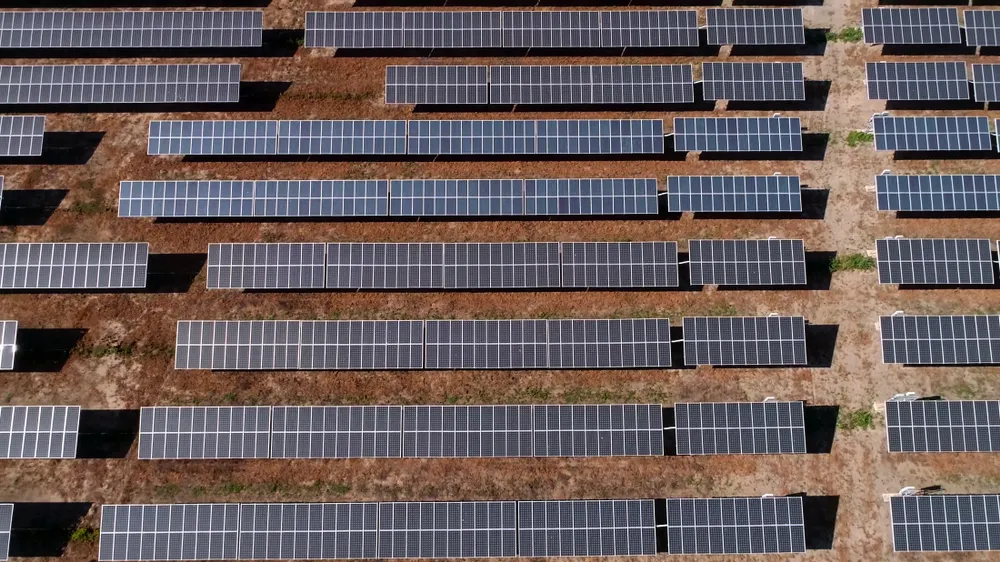 Aerial view of a solar panel field in Saudi Arabia, showcasing rows of solar panels for renewable energy production.